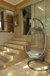 a chair on the front porch of a house at @Home Guest House in Rustenburg