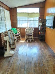 a room with wooden floors and chairs and a window at BS.homestay mindfulness and well-being in Phra Nakhon Si Ayutthaya