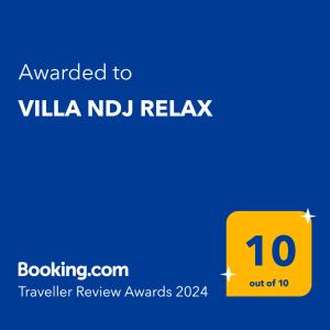 a yellow sign with the text awarded to vla n idil relaq at VILLA NDJ RELAX in Tsoukaladhes