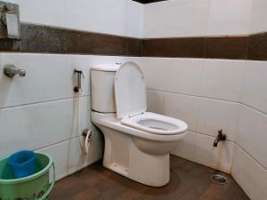 a bathroom with a toilet with the lid up at Hotel Taj Prince in Agra