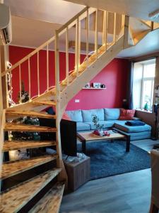 sala de estar con sofá y escalera en Le Coin Rocheux en La-Roche-en-Ardenne