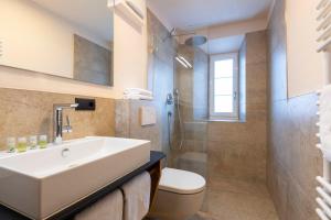 a bathroom with a sink and a toilet and a shower at NATURPARKGUT - Apartment HOLZGAU1758 in Holzgau +46 photos