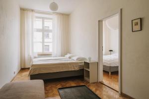 a bedroom with two beds and a mirror at HERE Apartments in Krakow