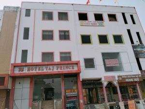 a large white building with a sign on it at Hotel Taj Prince in Agra