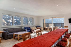 a room with a long table with chairs and a couch at App 20 Personen Innerspielleiten in Hippach