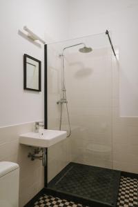 a bathroom with a sink and a shower at HERE Apartments in Krakow