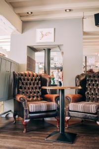 two leather chairs and a table in a store at The Star in West Leake