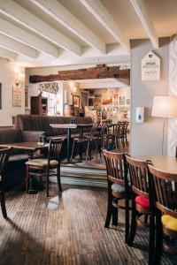 a restaurant with tables and chairs and a bar at The Star in West Leake