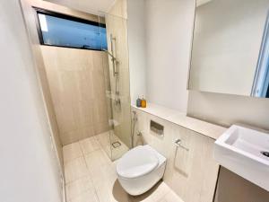 a white bathroom with a toilet and a sink at LA 1-10 Pax Cozy Home Tropicana 3Rooms 4QBeds Wifi&TV in Petaling Jaya +16 photos