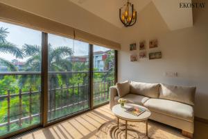 a living room with a couch and large windows at EKOSTAY Luxe - Casa Marina in Candolim