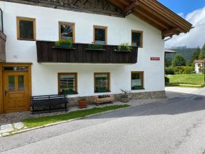 een huis met een balkon met planten erop bij Schneiderhof in Seefeld in Tirol