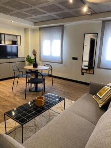 a living room with a couch and a table at Bubu - Nuevo edificio de apartamentos en el centro in Málaga