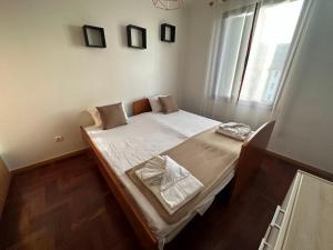 a small bed in a room with a window at FUNCHAL APARTMENT WITH POOL - Garajau 2 in Caniço +19 photos