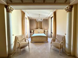 a bedroom with a bed and two chairs at Hotel Kazar in Ontinyent