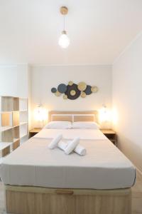 - une chambre avec un grand lit blanc et 2 serviettes dans l'établissement Nautical Flats by Concept, à Valence