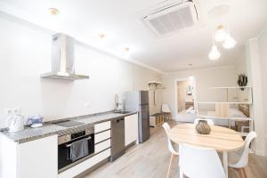 a kitchen and dining room with a table and chairs at Nautical Flats by Concept in Valencia