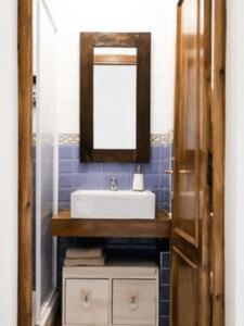 a bathroom with a sink and a mirror at Serranos Flat by Concept Flats in Valencia