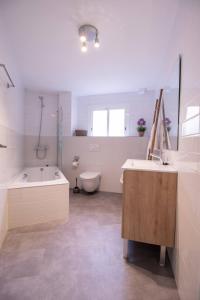 a bathroom with a tub and a sink and a toilet at Old Town Flat by Concept Flats in Valencia