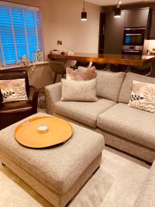 a living room with a couch and a table at The Mews Cottage, with parking, Yarm in Yarm