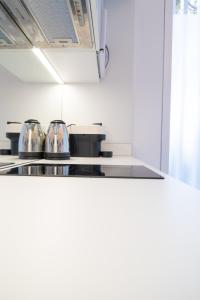 a kitchen with silver pots and pans on a counter at Marino by Clink in Valencia