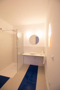 a white bathroom with a sink and a shower at Marino by Clink in Valencia
