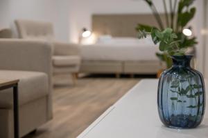 um vaso azul sentado numa mesa numa sala de estar em Cid Flats by Concept em Valência