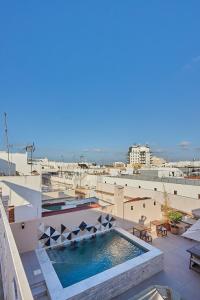 a swimming pool on the roof of a building at VG - Villa de Andas suites in Cádiz