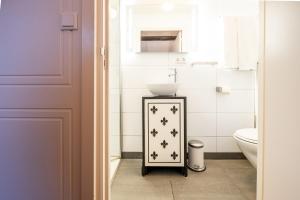 a bathroom with a sink and a toilet at Hotel Restaurant Café Parkzicht in Roermond