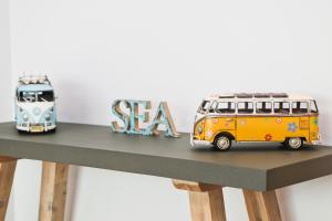 two toy buses sitting on top of a table at Sea view apartment, first floor in Saint Merryn