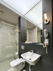 a bathroom with a sink and a toilet and a mirror at Black Gold Center in Chorzów
