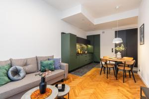 a living room with a couch and a table at SuperApart Grochowska 326 in Warsaw