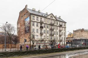 a large white building with people walking in front of it at SuperApart Grochowska 326 in Warsaw