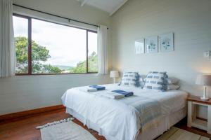 a bedroom with a bed and a large window at Mar Azul 1B in Ponta Malongane