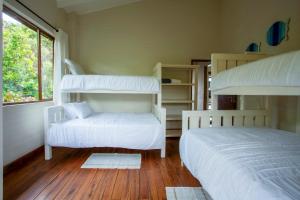 a bedroom with two bunk beds and a window at Mar Azul 1B in Ponta Malongane