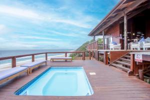 a house with a swimming pool on a deck at Mar Azul 1B in Ponta Malongane