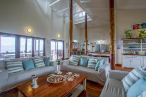 a living room with couches and a table at Mar Azul 1B in Ponta Malongane