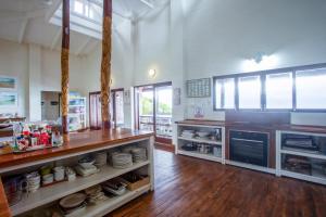 a large kitchen with a counter with dishes on it at Mar Azul 1B in Ponta Malongane