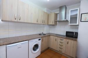 a kitchen with a washer and dryer in it at DIFFERENTFLATS Decathlon in Salou