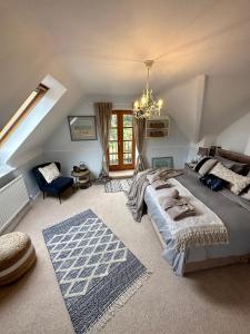 a bedroom with a large bed and a chandelier at Awakening Alchemy Retreat Centre in Inverurie