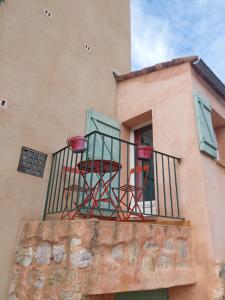 two chairs on the balcony of a building at Gite Europa in Le Mas