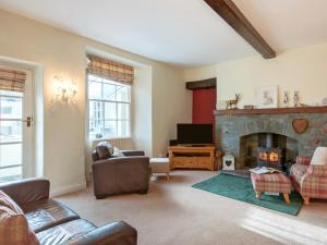 a living room with a fireplace and a tv at 3 Bed in Sawrey 62587 in Far Sawrey