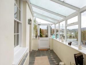 a glass conservatory with a door and windows at 3 Bed in Sawrey 62587 in Far Sawrey