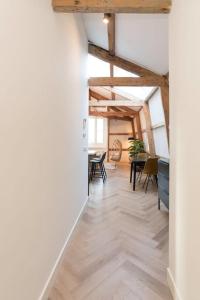 un pasillo abierto con techos de madera, mesas y sillas en Cozy B&B Prinsengracht en Ámsterdam