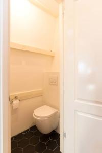 uma casa de banho com um WC branco num quarto em Cozy B&B Prinsengracht em Amesterdão