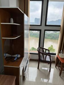 a room with a desk and a chair and a large window at Thiên Thiên Thanh in Lao Cai