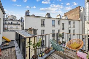 an apartment balcony with a hammock and chairs at Duplex familial à necker by Weekome in Paris