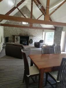 a living room with a wooden table and chairs at Culter Place in Biggar