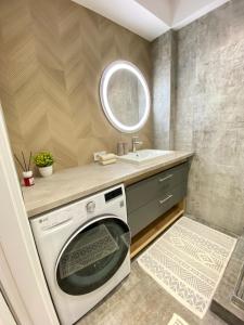 a laundry room with a washing machine and a sink at RentNow Large and Cozy Apartment in the Center, Parking in Chişinău +280 photos