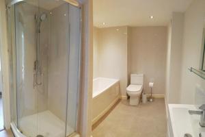 a bathroom with a tub and a toilet and a shower at Culter Place in Biggar