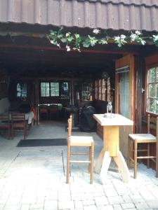 a wooden table and two chairs in a building at Haus Biggi - Ferienwohnung Säntis in Weiler-Simmerberg